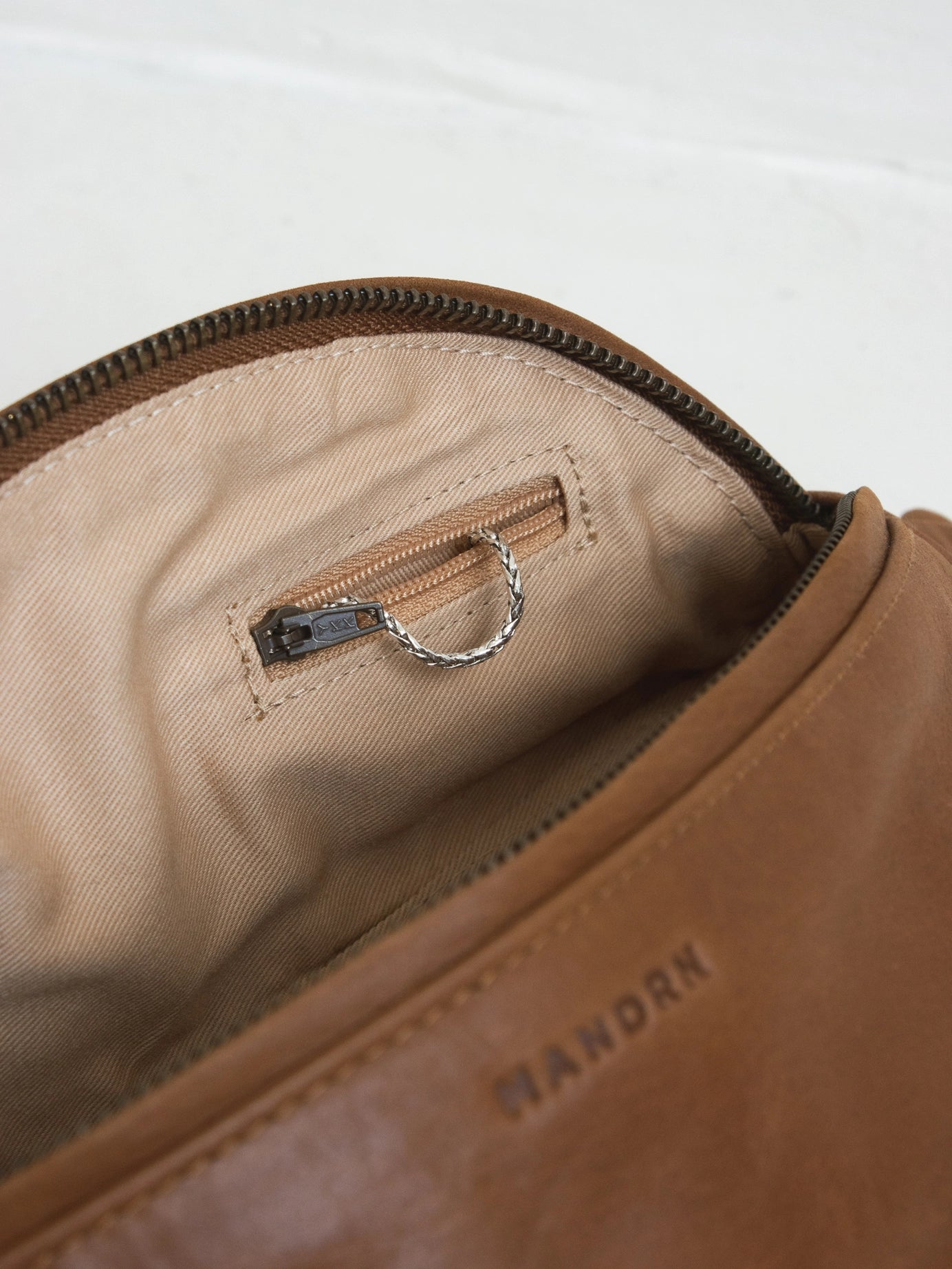 Zipper pocket Inside of mandrn atlas fanny pack in tan