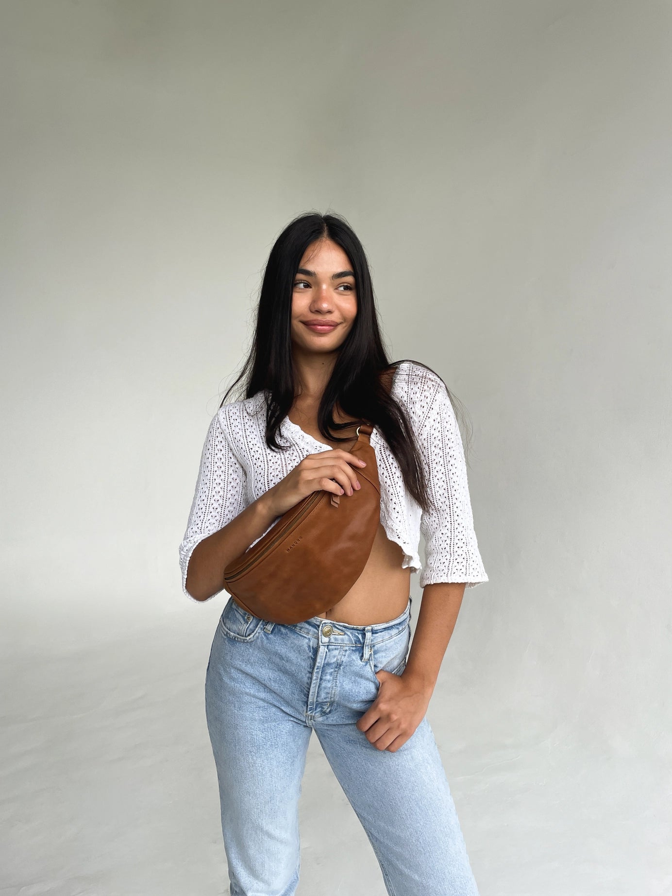 Mandrn leather atlas fanny pack on model in color tan