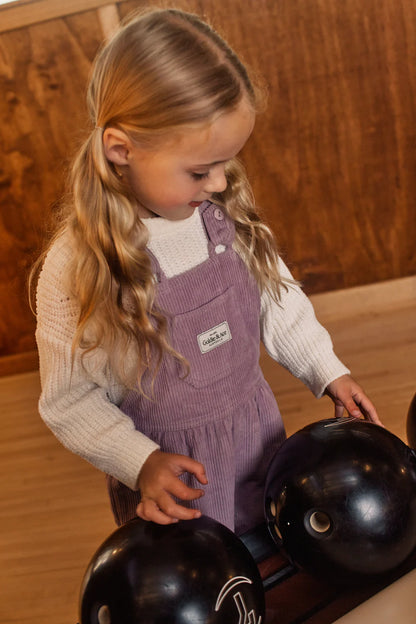 Girl wearing Goldie & Ace Sammy corduroy overalls in lilac